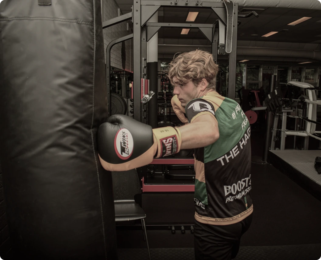 Man hitting heavy bag with boxing glove